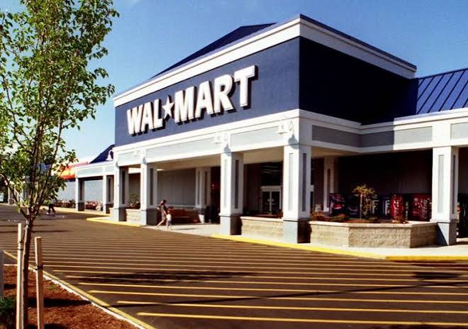 Walmart store with a blue and white sign on the front, surrounded by trees and plants