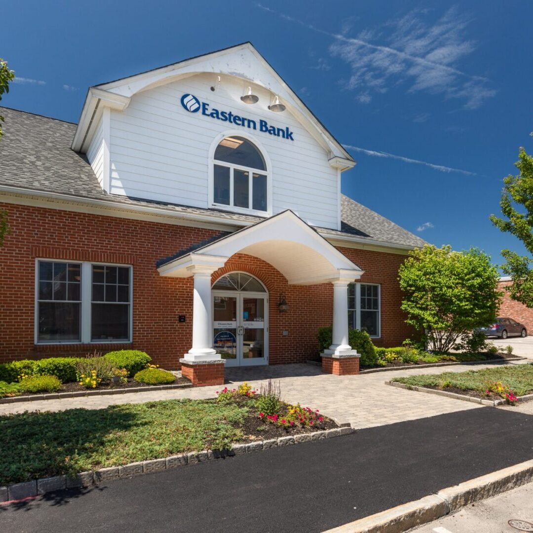 Exterior of an building with a parking lot in front of it